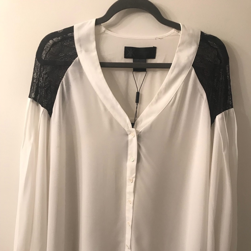 White Kardashian blouse with black lace shoulders